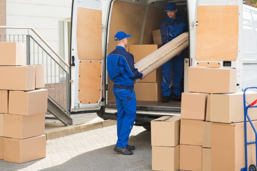 Furniture pick-up service in London removing a sofa from a home