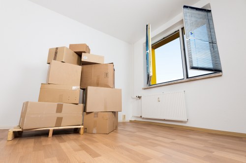 Professional London movers loading secured belongings into a removal vehicle