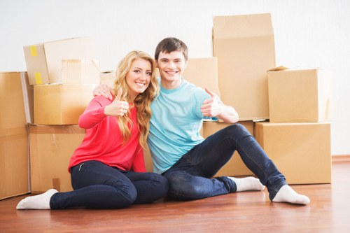 Moving team carrying furniture from a city apartment