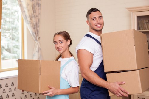 Residential furniture removal service preparing sofas and tables for transport in London