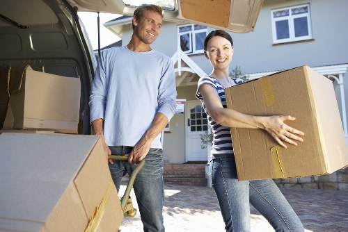 Moving specialists carefully loading furniture for transport